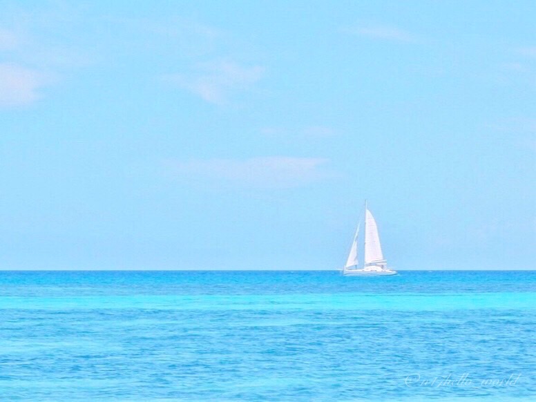 A white sailboat on New Caledonia’s blue lagoon